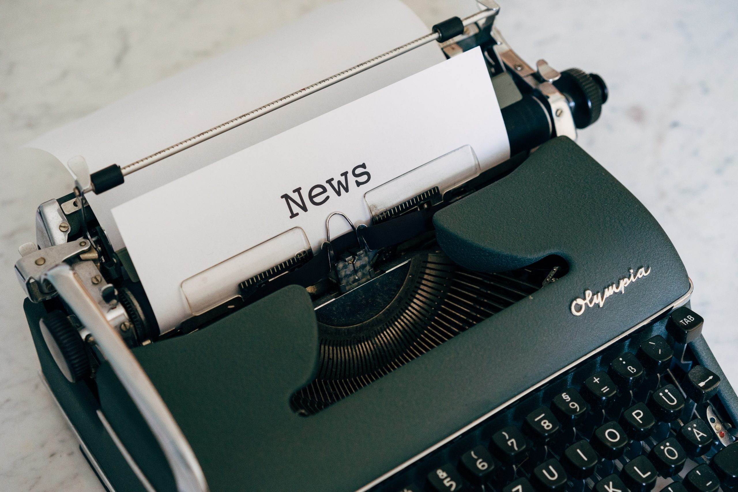 typewriter with the word news
